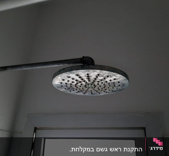 התקנת ראש גשם במקלחת.